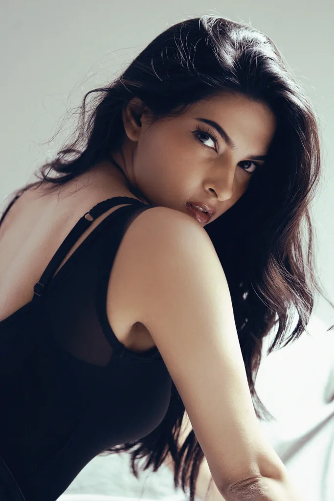 Beauty portrait, model looking over her shoulder in black, photographed by Shreyak Singh