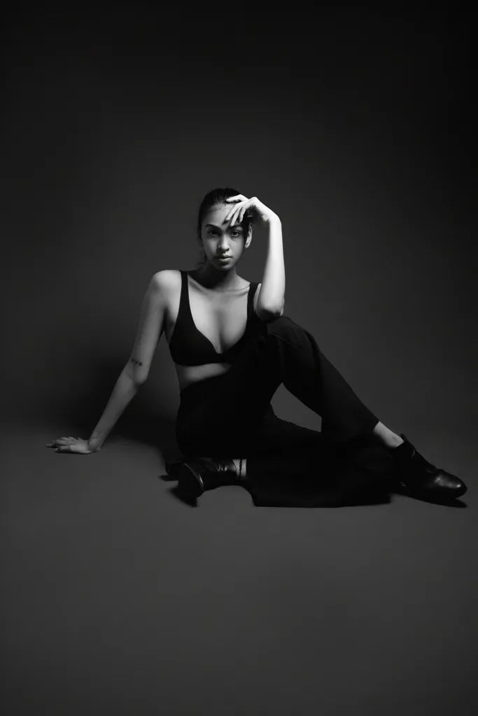 Black and white studio fashion photograph, model on the floor, photographed by Shreyak Singh