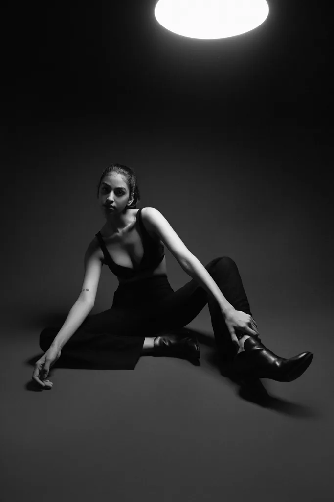 Black and white studio photograph with a single overhead light, photographed by Shreyak Singh
