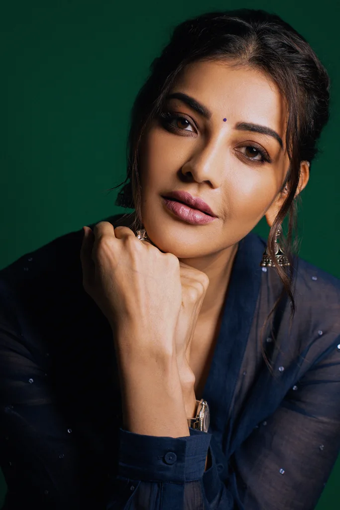 Portrait in a black jacket against a dark green backdrop, photographed by Shreyak Singh