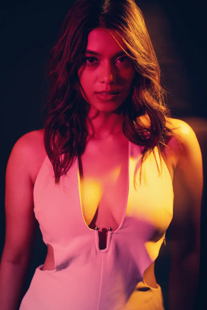 Fashion photograph in a pink halter top with warm backlight, photographed by Shreyak Singh