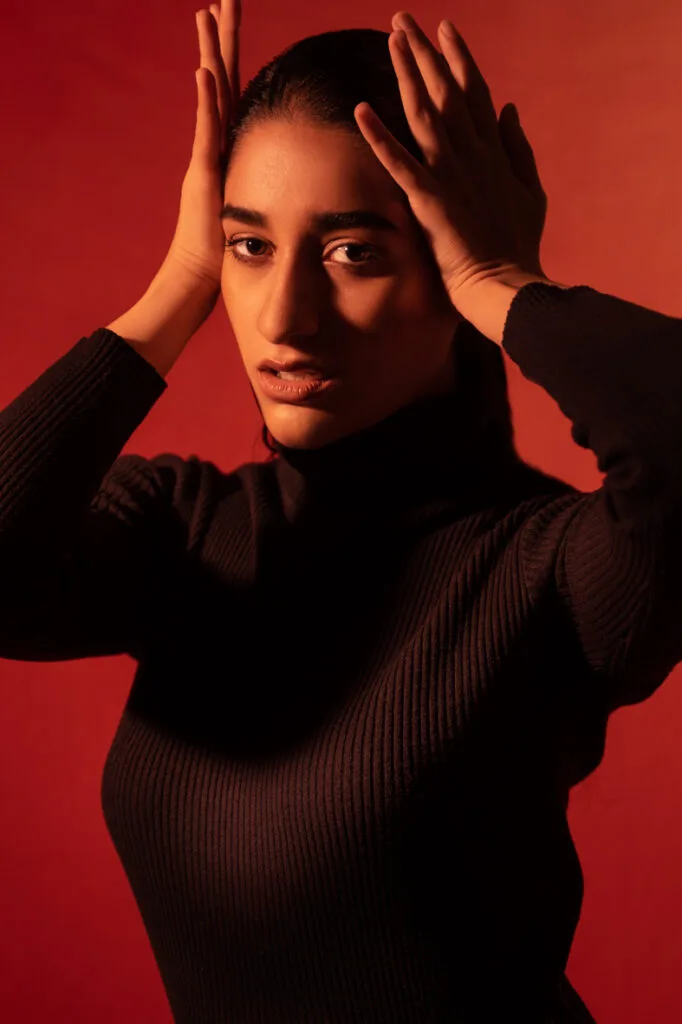 Fashion portrait in red and green gel lighting, photographed by Shreyak Singh