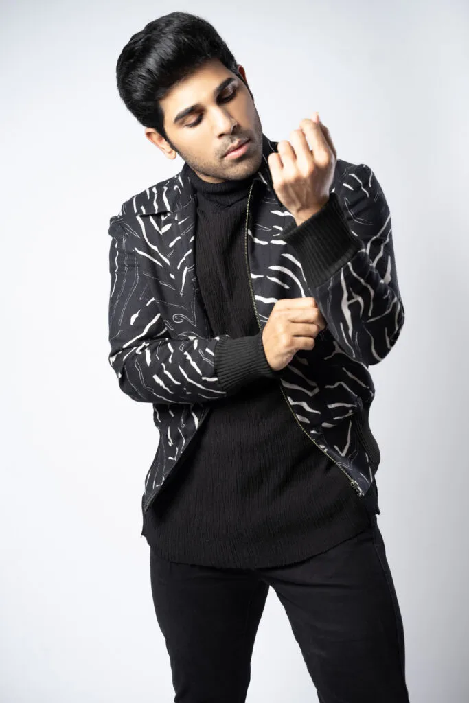 Menswear portrait in a black embroidered jacket, photographed by Shreyak Singh