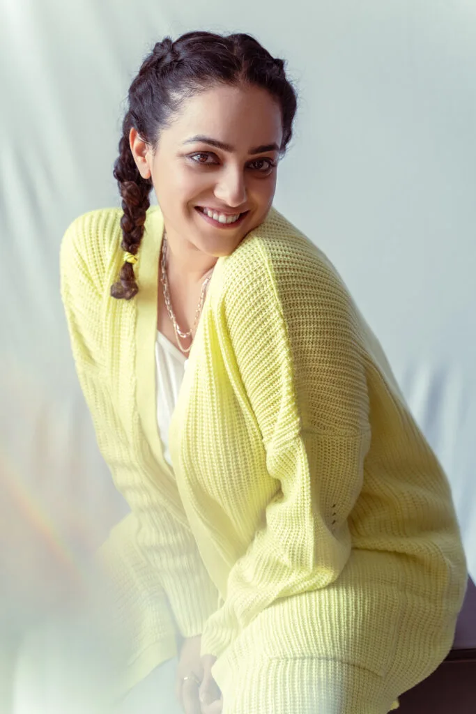 Fashion portrait in a yellow cardigan against a white sheet, photographed by Shreyak Singh